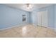 Serene bedroom with light blue walls, neutral tile floors, and a bright, airy feel at 6131 Tedder St, Port Charlotte, FL 33981