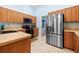 Kitchen with stainless steel refrigerator and wooden cabinets at 6131 Tedder St, Port Charlotte, FL 33981