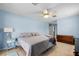 Main bedroom featuring a ceiling fan and neutral tile flooring at 6131 Tedder St, Port Charlotte, FL 33981