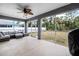 Relaxing screened-in patio with ceiling fan and outdoor seating area at 6131 Tedder St, Port Charlotte, FL 33981