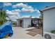 Backyard with an open shed, outdoor kitchen and mature landscaping with blue skies overhead at 6531 Clair Shore Dr, Apollo Beach, FL 33572