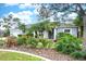 Beautiful home with a lush front yard, mature trees, and manicured flowerbeds create inviting curb appeal at 6531 Clair Shore Dr, Apollo Beach, FL 33572