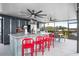 Outdoor kitchen featuring a large island, stainless steel appliances, and red bar stools at 6531 Clair Shore Dr, Apollo Beach, FL 33572