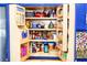 Well-stocked pantry with adjustable shelves, filled with snacks, sauces, and canned goods at 6531 Clair Shore Dr, Apollo Beach, FL 33572