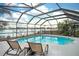 Inviting screened-in pool with waterfront views and comfortable lounge seating at 6531 Clair Shore Dr, Apollo Beach, FL 33572