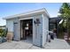 Well-organized shed with ample storage and workspace, including a screened in outdoor room at 6531 Clair Shore Dr, Apollo Beach, FL 33572