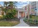 Exterior of the community clubhouse featuring a small entryway and manicured landscaping at 6800 20Th N Ave # 405, St Petersburg, FL 33710