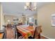 Dining room with a colorful table cloth, hardwood floors, and views of the living room at 6800 20Th N Ave # 405, St Petersburg, FL 33710