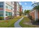 Exterior view of condo buildings featuring sidewalks and green landscaping at 6800 20Th N Ave # 405, St Petersburg, FL 33710