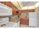 A well-lit kitchen featuring granite countertops, and white appliances at 6800 20Th N Ave # 405, St Petersburg, FL 33710