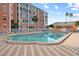 Community pool with surrounding lounge chairs and building in the background at 6800 20Th N Ave # 405, St Petersburg, FL 33710