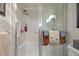 Shower with glass door, built-in shelving, and accessibility handrails at 6800 20Th N Ave # 405, St Petersburg, FL 33710