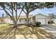 Charming single-story home with a well-manicured lawn and mature trees shading the front at 7200 Arbor View Ln, New Port Richey, FL 34653