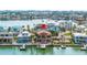 Aerial view of a waterfront home with a private dock and pool at 854 Bay Point Dr, Madeira Beach, FL 33708