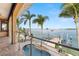 Balcony featuring a private pool and beautiful water views, perfect for enjoying the coastal lifestyle at 854 Bay Point Dr, Madeira Beach, FL 33708