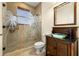 Bathroom featuring glass enclosed shower with palm tree design and modern vanity at 854 Bay Point Dr, Madeira Beach, FL 33708