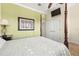 Cozy bedroom with dark wood bed frame, carpeted floor, and flat screen tv at 854 Bay Point Dr, Madeira Beach, FL 33708