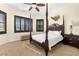 Bedroom with four-poster bed, plantation shutters, neutral walls, and carpeted floors at 854 Bay Point Dr, Madeira Beach, FL 33708