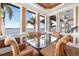 Bright dining room featuring a glass table, comfortable seating, and scenic waterfront views from every angle at 854 Bay Point Dr, Madeira Beach, FL 33708