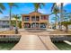 Waterfront home boasts outdoor living with a pool, dock, and beautiful landscaping at 854 Bay Point Dr, Madeira Beach, FL 33708