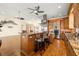 Kitchen island with granite countertop, seating, and stainless steel range hood at 854 Bay Point Dr, Madeira Beach, FL 33708