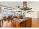 Kitchen island with granite countertop, seating, and stainless steel range hood and lake view at 854 Bay Point Dr, Madeira Beach, FL 33708