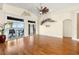 Bright living room with wood floors, vaulted ceiling, and sliding glass doors to a waterfront balcony at 854 Bay Point Dr, Madeira Beach, FL 33708