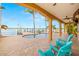 Covered patio with a private pool, waterfront views, and lounge seating perfect for outdoor entertaining at 854 Bay Point Dr, Madeira Beach, FL 33708