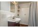 Full bathroom featuring a classic tile shower and updated sink vanity at 932 Lexington Dr, Dunedin, FL 34698