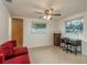 Bedroom with two windows, ceiling fan, and desk at 932 Lexington Dr, Dunedin, FL 34698