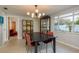 Dining room with modern lighting, ample natural light and view to the backyard at 932 Lexington Dr, Dunedin, FL 34698