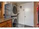 Convenient laundry area featuring modern, stacked washer and dryer units, maximizing space and efficiency at 932 Lexington Dr, Dunedin, FL 34698