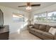 Cozy living room with natural light and a comfortable sofa, perfect for relaxing and entertaining guests at 932 Lexington Dr, Dunedin, FL 34698