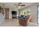 Cozy living room features a ceiling fan, large window, and comfortable seating at 932 Lexington Dr, Dunedin, FL 34698