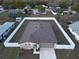 Aerial view of a fenced property featuring a well-manicured lawn and a cozy single-story home at 9377 Benrock Rd, Spring Hill, FL 34608