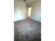 Bedroom featuring neutral carpet, closet space, and natural light at 9377 Benrock Rd, Spring Hill, FL 34608