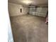 Spacious two car garage with concrete floor and an automatic door at 9377 Benrock Rd, Spring Hill, FL 34608