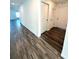 Inviting hallway featuring modern wood-style flooring, and ample closet space at 9377 Benrock Rd, Spring Hill, FL 34608