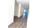 Hallway showcases wood-look floors and leads to rooms bathed in natural light at 9377 Benrock Rd, Spring Hill, FL 34608