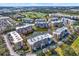 A wide aerial view of the Golf Lake community showcasing lush landscaping, water features, and beautiful condos at 960 Starkey Rd # 3106, Largo, FL 33771