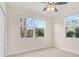 Comfortable bedroom showcasing two windows with natural light, a ceiling fan, and neutral carpeting at 960 Starkey Rd # 3106, Largo, FL 33771