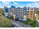 Condominium building with many balconies, parking and lush trees at 960 Starkey Rd # 3106, Largo, FL 33771