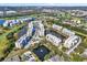 Aerial view of the Golf Lake Condominiums complex, with multiple pools, ponds and lush grounds at 960 Starkey Rd # 3106, Largo, FL 33771