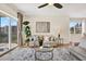 Cozy living room with a large plant, modern artwork, a ceiling fan, and a sliding door to balcony at 960 Starkey Rd # 3106, Largo, FL 33771