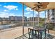 Relaxing screened patio with a ceiling fan offers a stunning view of the waterfront and fountain at 960 Starkey Rd # 3106, Largo, FL 33771