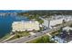High angle aerial showing multiple condo buildings with waterfront views, lush landscaping and boat docks at 100 Bluff View Dr # 514A, Belleair Bluffs, FL 33770