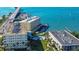 Aerial view of waterfront condos, pool, boat docks, landscaping and city view at 100 Bluff View Dr # 514A, Belleair Bluffs, FL 33770
