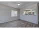 Open concept dining area with wood floors and view into a white and stainless kitchen at 100 Bluff View Dr # 514A, Belleair Bluffs, FL 33770