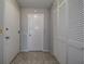 Neutral entryway featuring tile floors, storage closet, and white doors for a clean, welcoming entrance at 100 Bluff View Dr # 514A, Belleair Bluffs, FL 33770