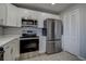 Modern kitchen with stainless steel appliances, white cabinets, and ample counter space for cooking at 100 Bluff View Dr # 514A, Belleair Bluffs, FL 33770